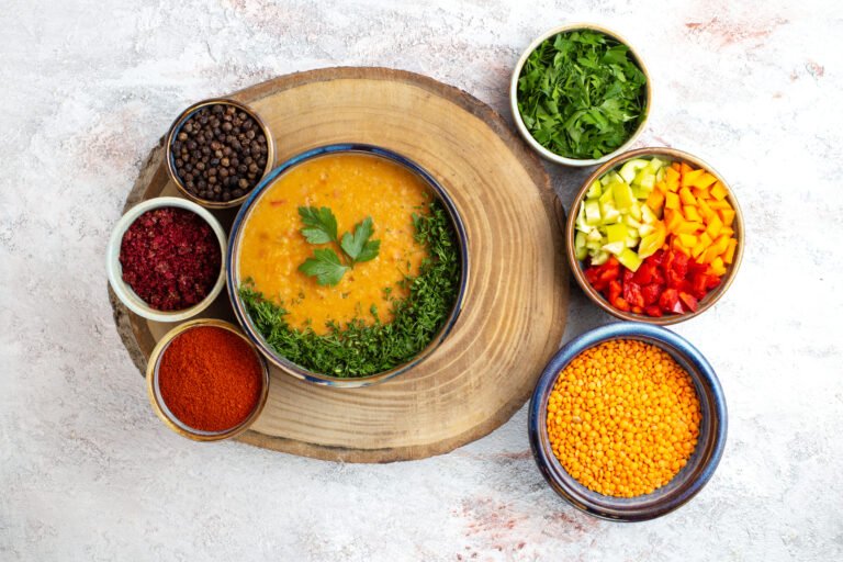 A nourishing bowl of healthy vegan food made with lentils, fresh herbs, and colorful vegetables